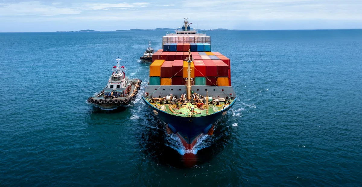 A container ship sailing with export goods from the port area to another destination