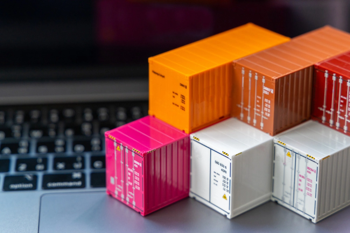 Miniature containers are arranged on a laptop